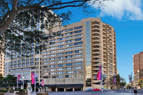 a tall building with pink flags in front of it at Apartment on Top of the Park in Sydney