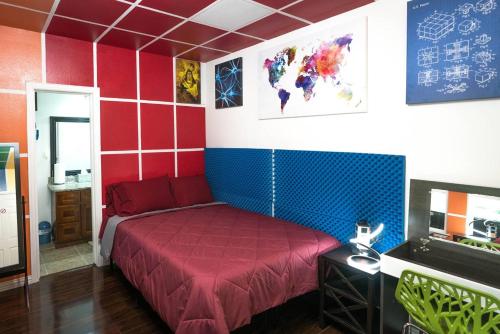 a bedroom with a red bed in a room at East Downtown Rubiks Studio in Houston