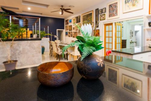 two vases sitting on top of a counter in a room at Luxury Penthouse 5 BDR 3 Bath Twin Rain Showers 365 sq mtrs in Port Douglas