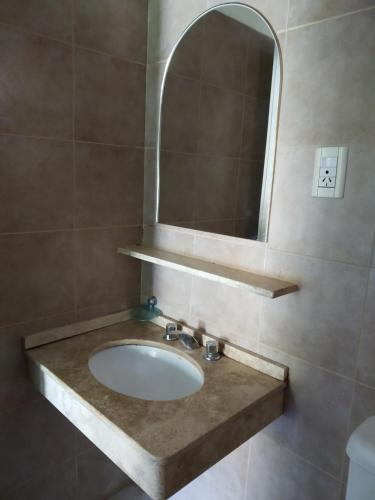 a bathroom with a sink and a mirror at posada cerro los nogales in San Agustín de Valle Fértil