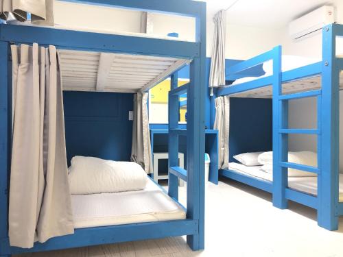 a bedroom with blue bunk beds in a room at Slow Citi Guest House -슬로시티게스트하우스 in Seogwipo