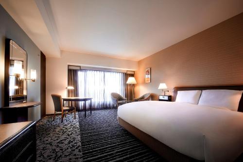 Un ou plusieurs lits dans un hébergement de l'établissement Hotel New Otani Osaka