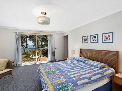 a bedroom with a large bed and a window at Stunning Ocean Views in Norah