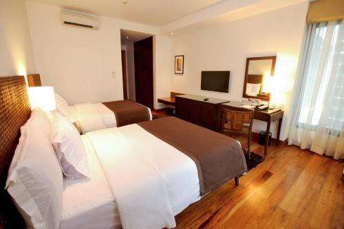Кровать или кровати в номере City Garden Grand Hotel