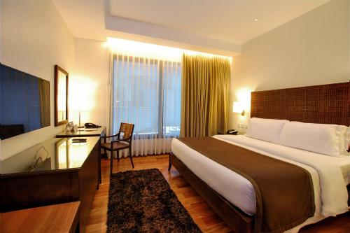 Кровать или кровати в номере City Garden Grand Hotel