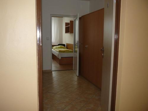 a hallway leading to a bedroom with a bed at Koleje J.A.Komenského in Brno