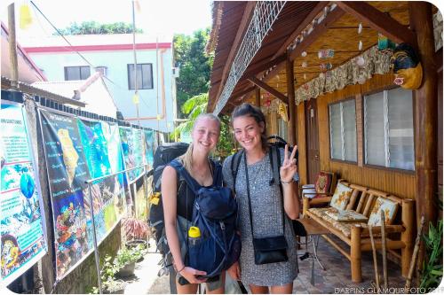 two women posing for a picture in front of a store at Darpins Guesthouse in Dauin