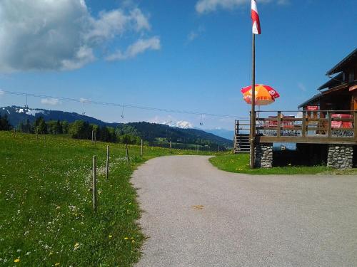 a road next to a building with an umbrella at Schedlers Löwenhotel-GARNI in Alberschwende
