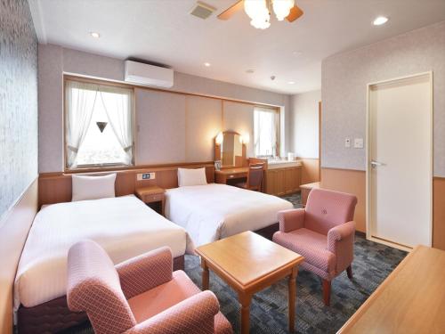 A bed or beds in a room at Green Rich Hotel Aso Kumamoto Airport (Artificial hot spring Futamata Yunohana)