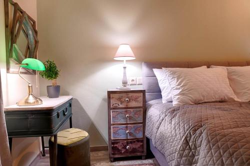 a bedroom with a bed and a table with a lamp at Sali Boutique hotel in Alexandroupoli