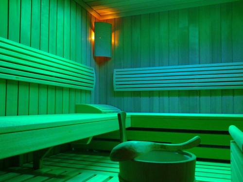 a green room with benches and a toilet at Schedlers Löwenhotel-GARNI in Alberschwende