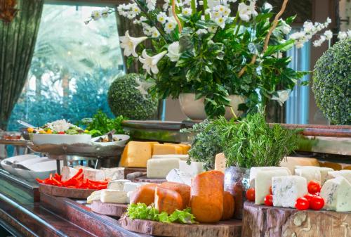 a buffet of cheese and vegetables on a table at Herods Palace Hotels & Spa Eilat a Premium collection by Fattal Hotels in Eilat