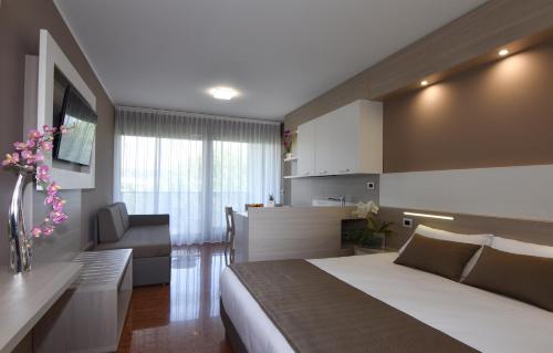 a hotel room with white walls and a large window at Residence all'Adige in Verona