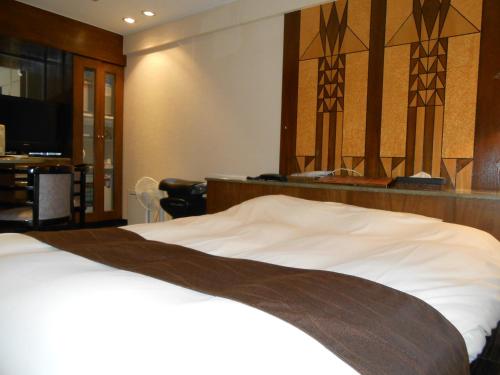 A bed or beds in a room at Hotel Lumiere Gotenba (Adult Only)