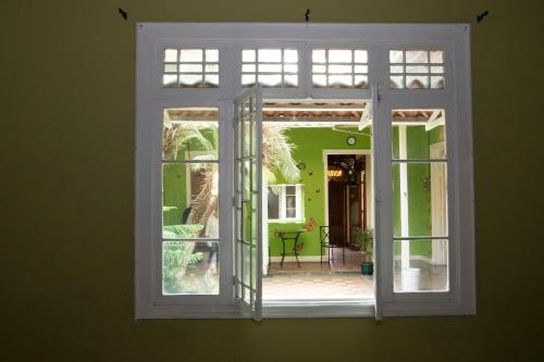 an open window looking out at a patio outside at Casa Mayela Guest House in San José