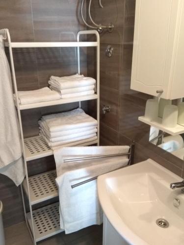 a bathroom with a towel rack next to a sink at Apartment Mario, Novalja in Novalja