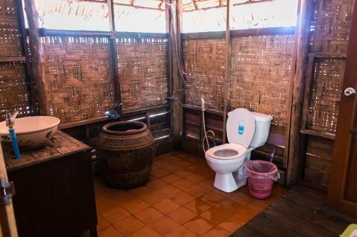 a small bathroom with a toilet and a sink at Horizon Eco Resort in Ko Phra Thong