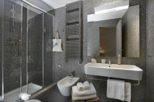 a bathroom with a sink and a toilet and a shower at Hotel Palazzo Grillo in Genova