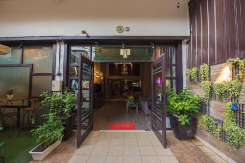 an open door of a building with potted plants at Homesyn Hotel in Phnom Penh