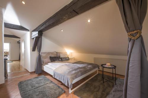 a bedroom with a bed and a table in a room at Sweet Dreams Appartements in Going am Wilden Kaiser