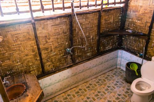 a bathroom with a toilet and a sink at Horizon Eco Resort in Ko Phra Thong