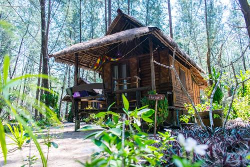 a wooden cabin in the woods with trees at Horizon Eco Resort in Ko Phra Thong