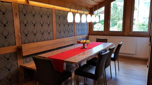 a dining room with a wooden table and chairs at Ferienhaus Ambiente in Ofterschwang