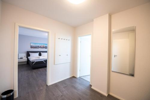 an empty room with a bed and a mirror at Parkhotel Nordwalde in Nordwalde