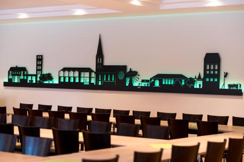 a conference room with a long table and chairs at Parkhotel Nordwalde in Nordwalde