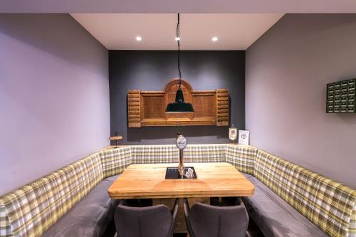 a booth in a restaurant with a wooden table and chairs at Parkhotel Nordwalde in Nordwalde