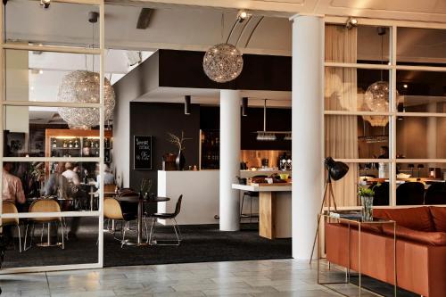 a living room with a couch and a table at Comwell Kolding in Kolding