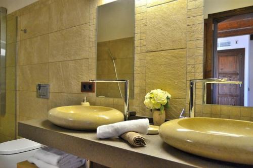 a bathroom with two sinks on a counter with a mirror at 065 Finca Son Costa ETV4943 by Mallorca Charme in Búger