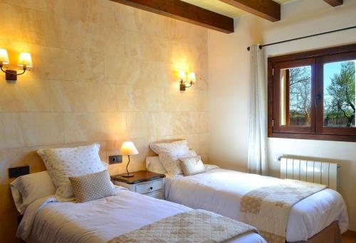 a bedroom with two beds and a window at 065 Finca Son Costa ETV4943 by Mallorca Charme in Búger