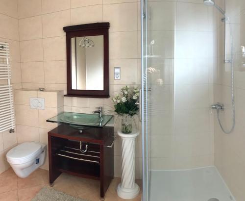 a bathroom with a sink and a shower and a toilet at Villa Relax Vendégház in Gárdony