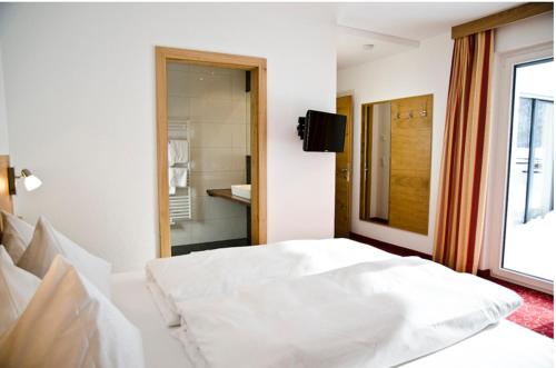 a bedroom with a white bed and a window at Chalet Barbara in Ischgl
