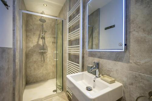 a bathroom with a sink and a shower at Heart of the City Luxury Apartment in York