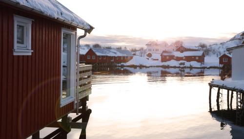 a house with a view of a body of water at Solsiden Brygge Rorbuer in Ballstad