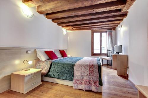 a bedroom with a bed with a wooden ceiling at Residenza Valier - Rialto in Venice