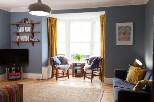 a living room with a table and chairs and a window at The Salt House, Fore Street in Ilfracombe
