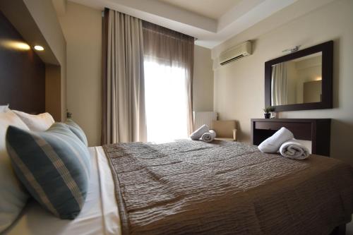 a hotel room with a bed with towels on it at Hotel Dionisos in Leptokaria