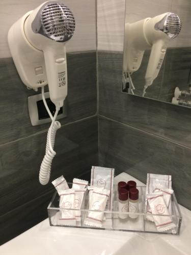 a bathroom with a blow dryer and a sink in a room at Live Naples in Naples