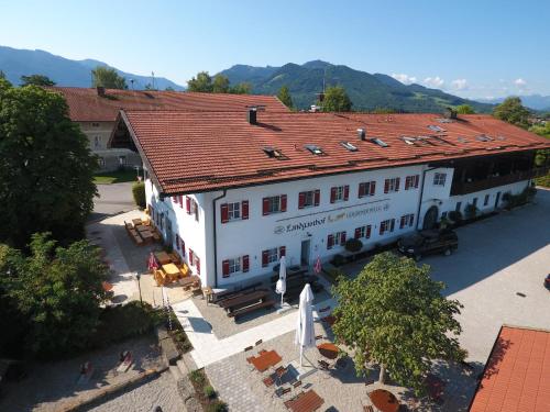 an overhead view of a large white building with a red roof at Landgasthof Goldener Pflug in Frasdorf