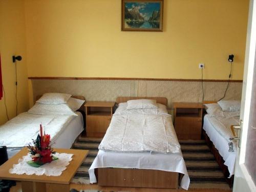A bed or beds in a room at Lugas Szallas