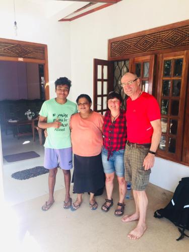 a group of people posing for a picture in a house at Summer Ridge - Homestay in Ratnapura