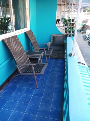 a patio with chairs and a couch on a building at Kata S. T. House in Kata Beach