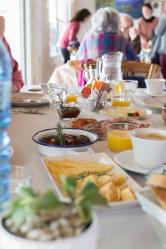a table topped with plates of food and drinks at Agroturismo Son Vives Menorca - Adults Only in Ferreries