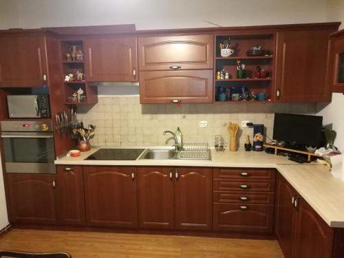 a kitchen with wooden cabinets and a sink at Cabana Festung in Bran