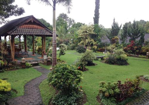 a garden with a gazebo and a path at KARANG SARI Guesthouse & Warung in Munduk