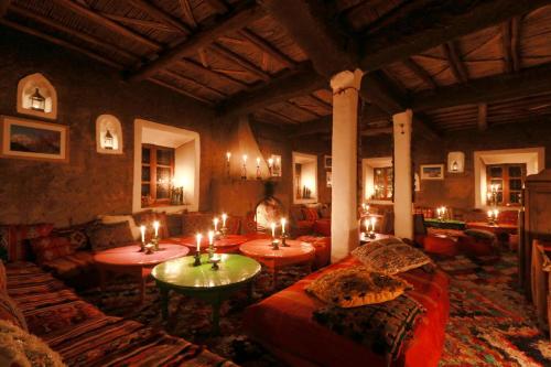a living room with candles on tables and couches at Douar Samra in Imlil