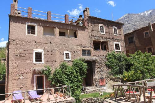 an old building with two people on the roof at Douar Samra in Imlil